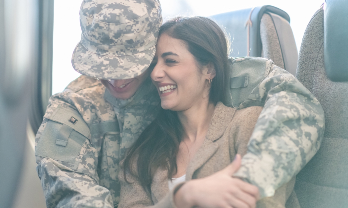 a male soldier hugging a female civilian