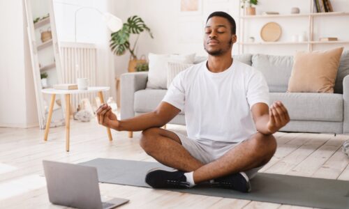 a man meditating in his living room