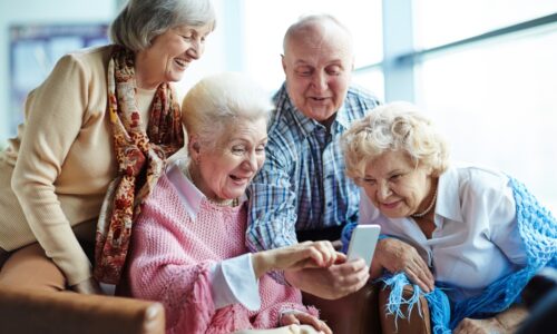 a group of seniors looking at a phone