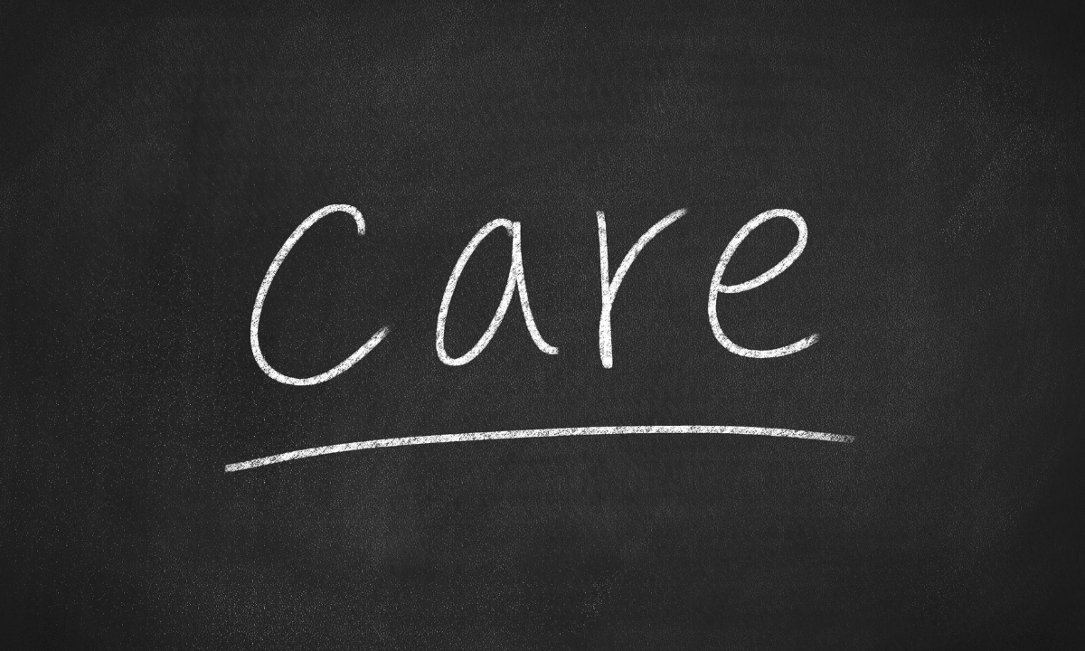 a blackboard that says "care" in white chalk
