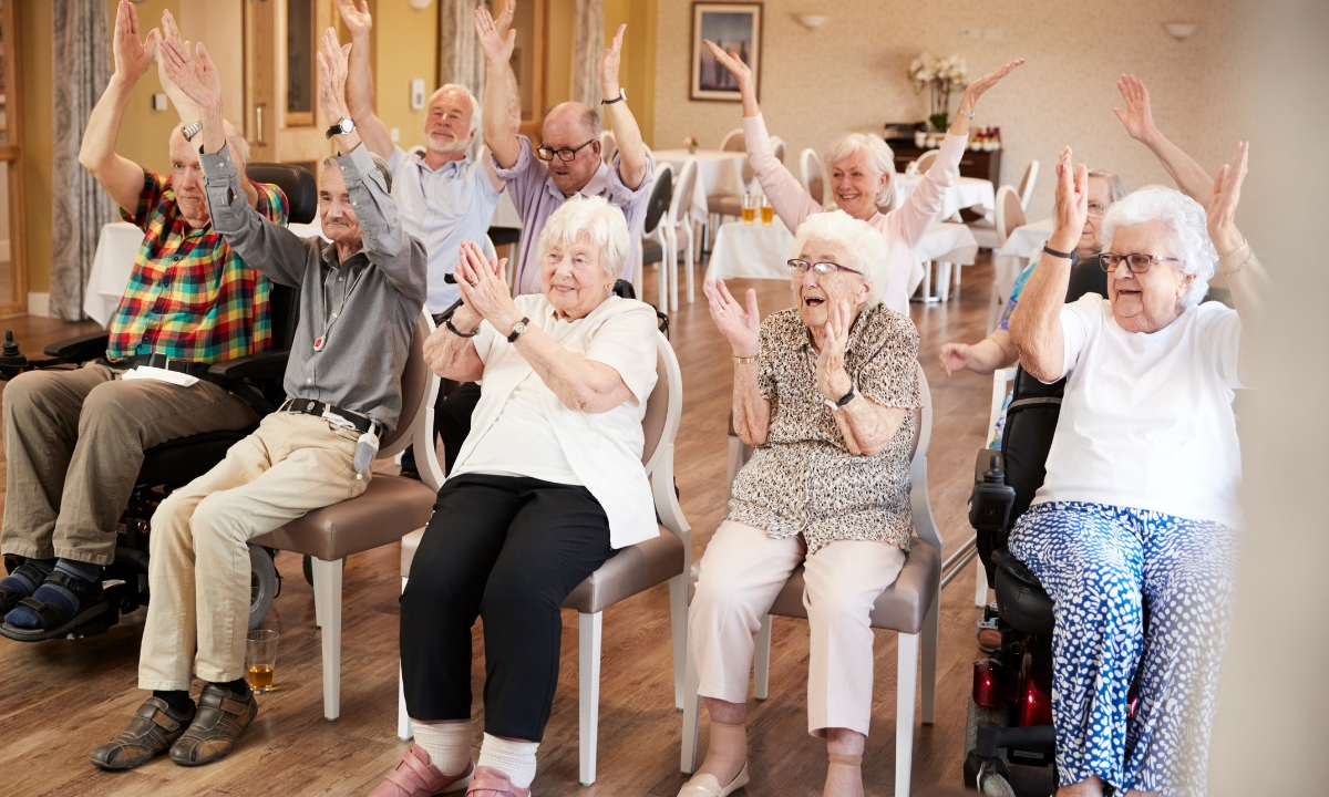 a group of seniors sitting in a circle and clapping