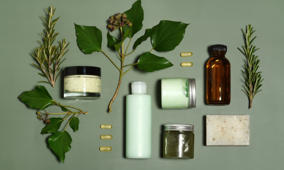 an assortment of pills, plants, soaps, and scrubs to signify self and respite care