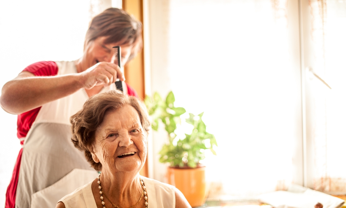 an elderly woman getting her hair cut