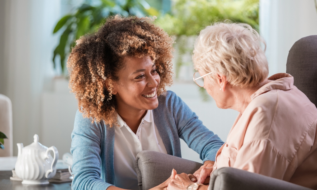 a woman sitting down opposite an elderly woman