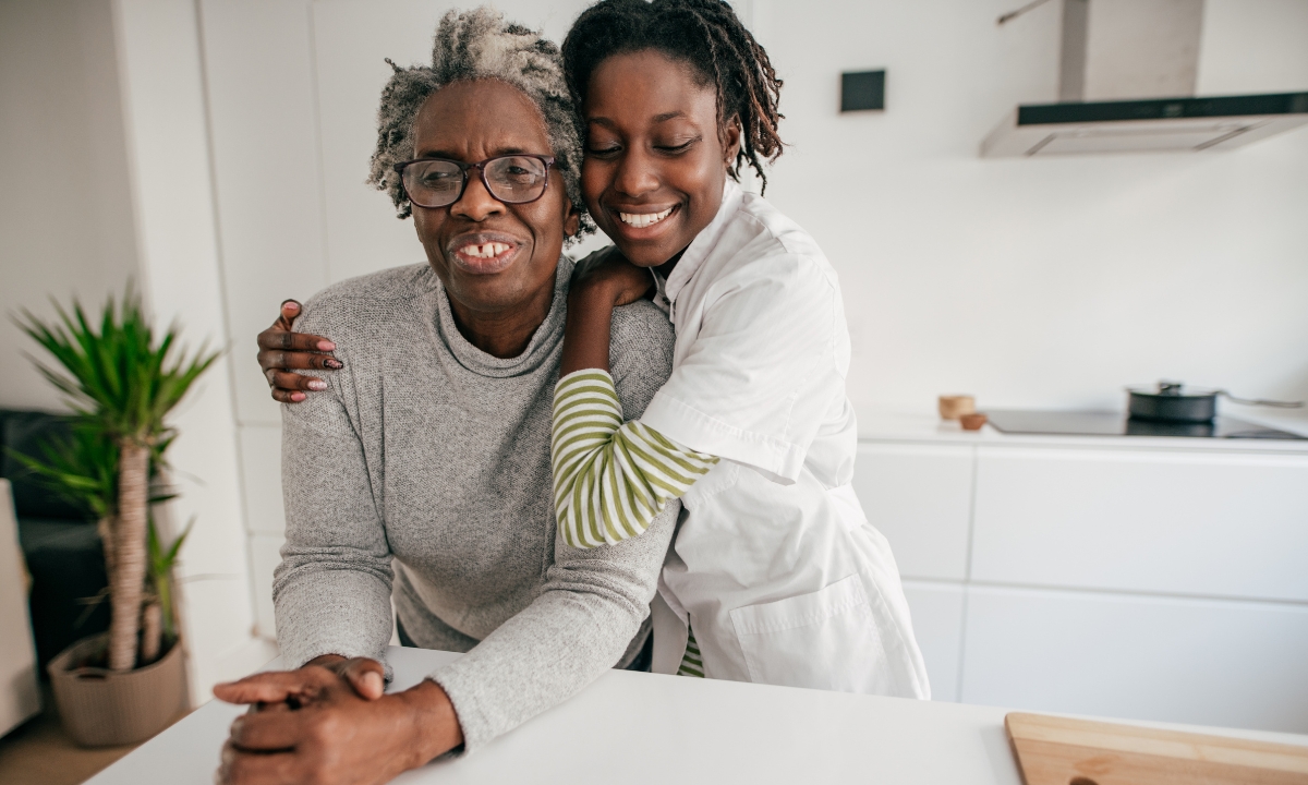 a middle aged woman hugging her elderly mother