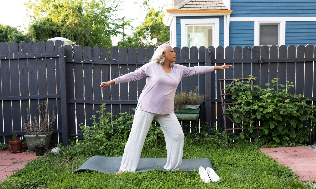 a woman doing yoga in her backyard