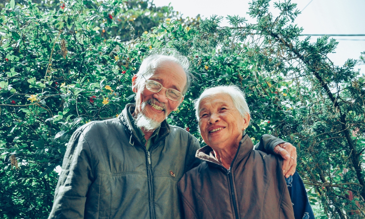 an elderly couple smiling