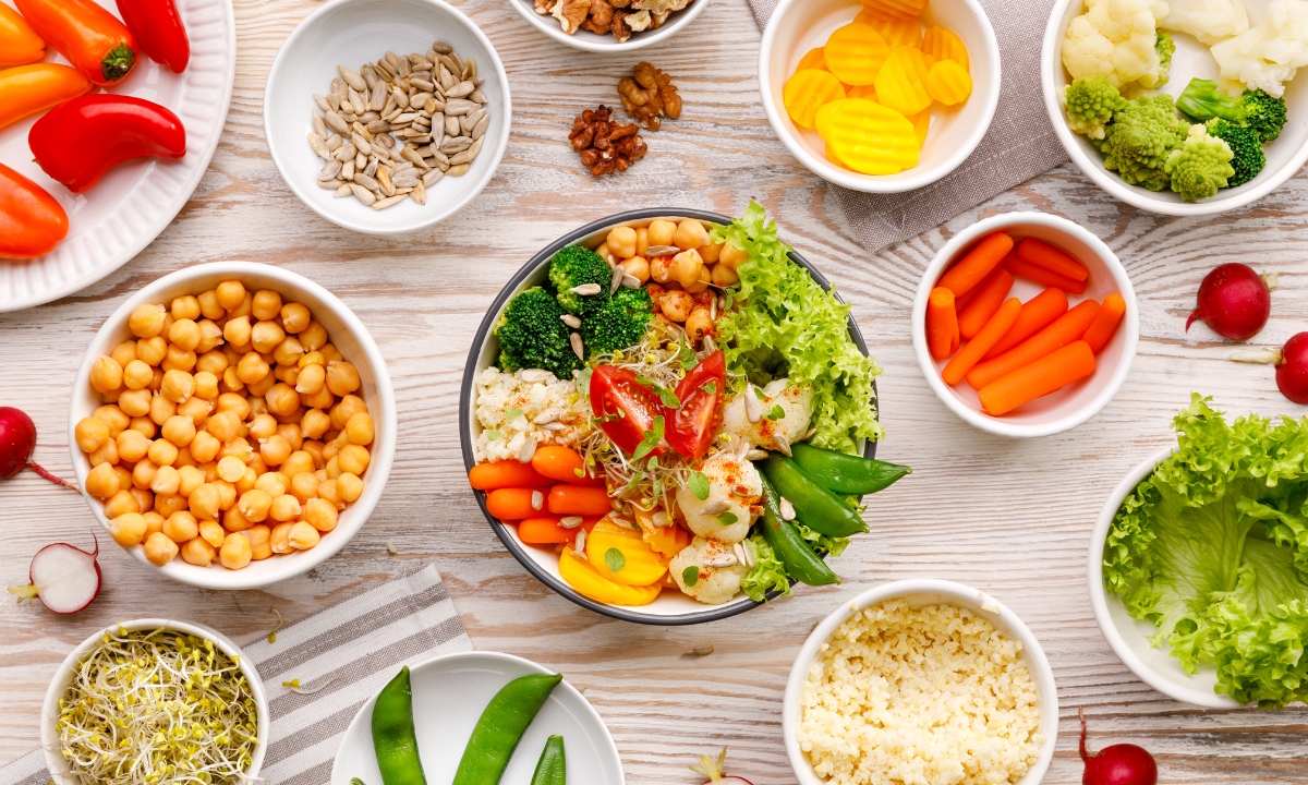 bowls of health foods; beans, seeds, chickpeas, carrots, etc.