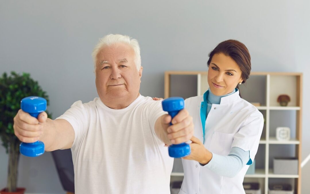 elderly man holding 2 blue 3 pound weights out to build strength